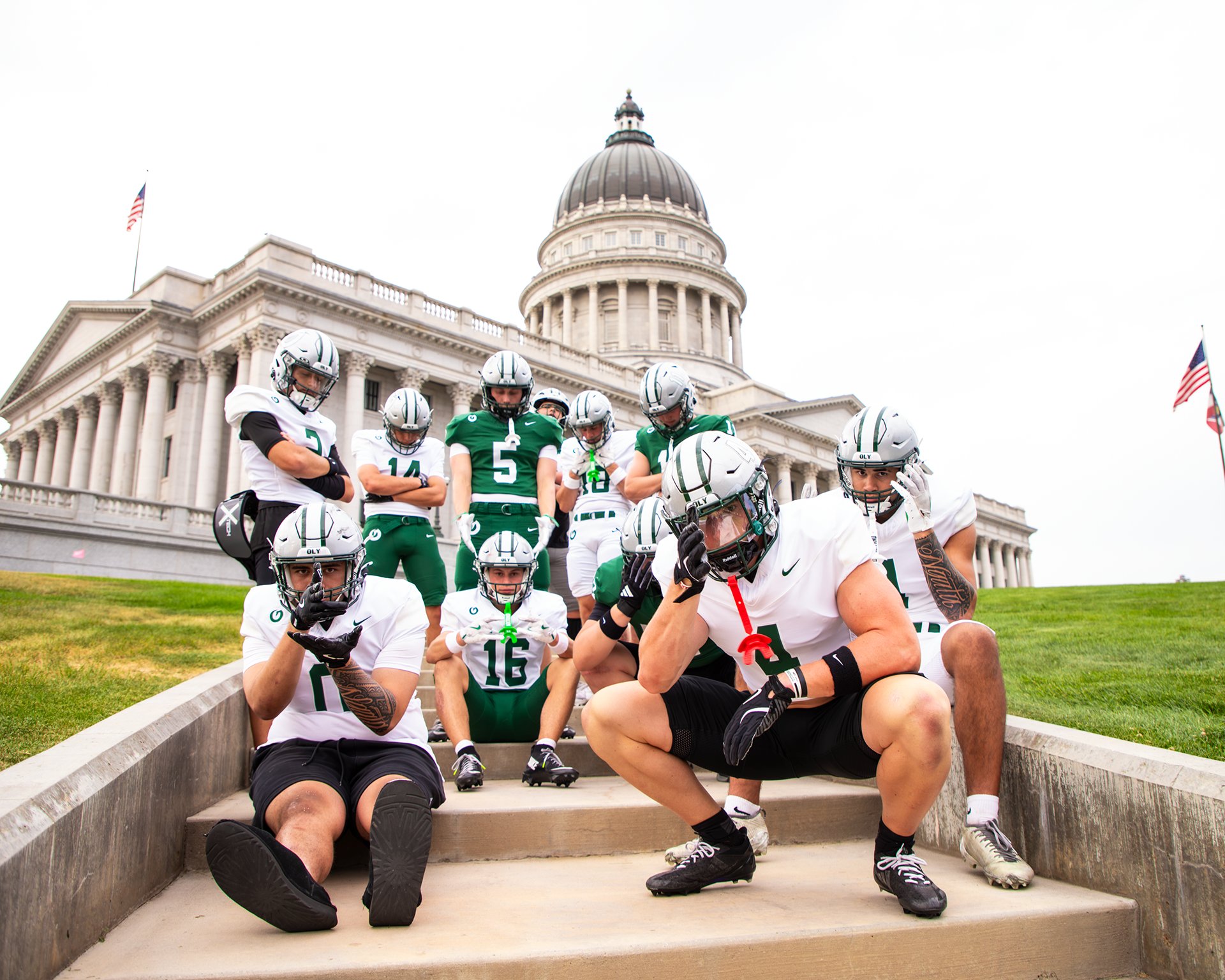Football team posed on the steps of the Utah State Capitol