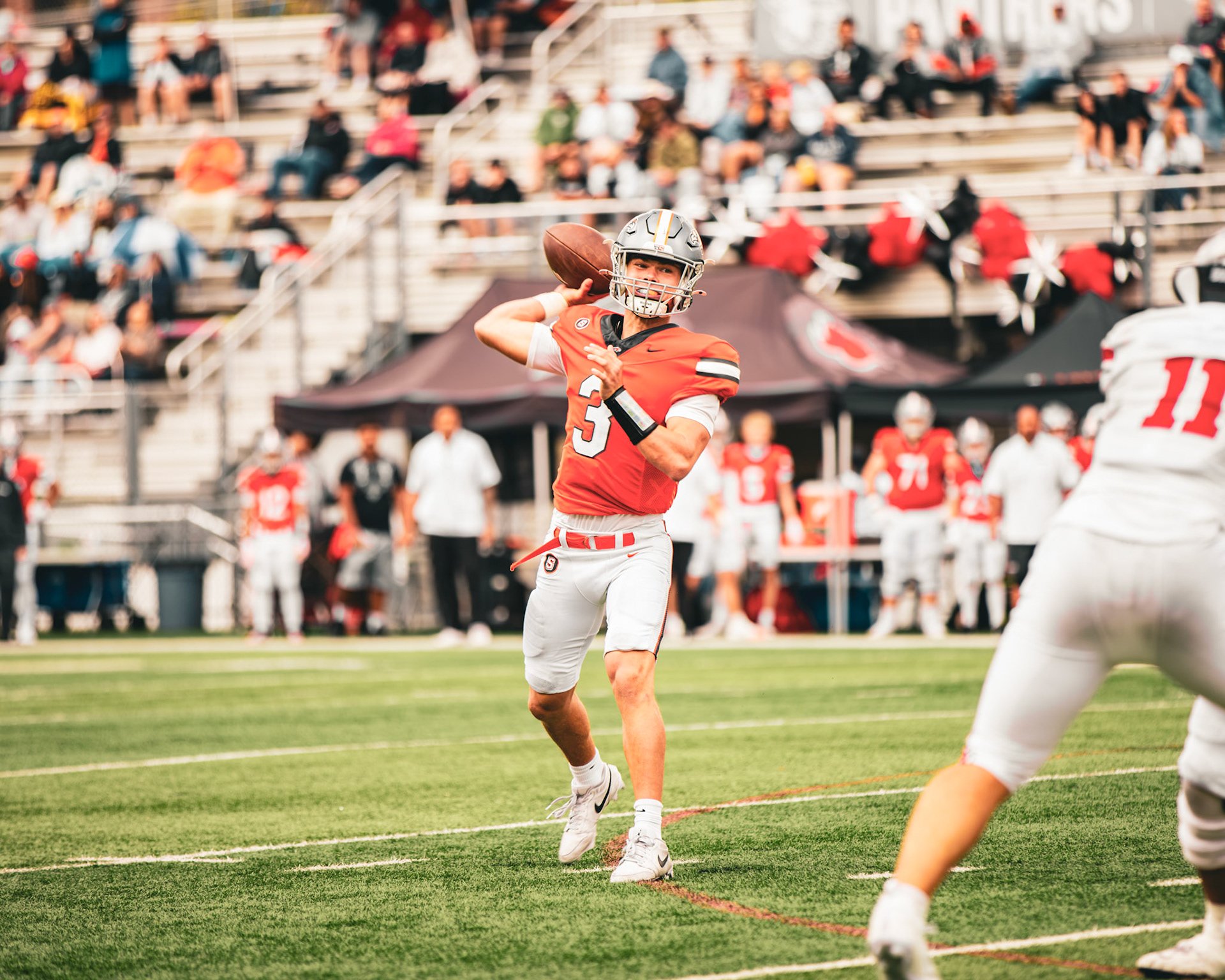 Quarterback in mid-throw during a game